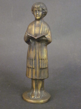 A bronze figure of a standing choir boy 7"
