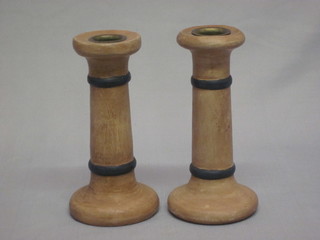 A pair of turned wooden candlesticks 6"