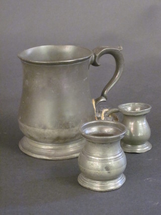A pewter baluster half pint tankard and 2 pewter measures