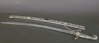 A reproduction Turkish style sabre with 27 1/2" curved blade  contained in an ornate scabbard