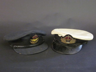 A Royal Navy Officer's peaked cap and a RAF Officer's cap