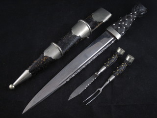 A Dirk with 11 1/2" blade and leather scabbard complete with knife and fork