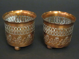 A pair of cylindrical pierced copper vases with embossed acorn decoration, base marked Made in England JS & S, 3"