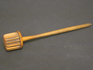 A wooden plunger with bladed head 11"