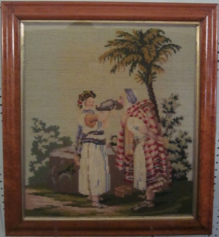 A Victorian Berlin wool work panel - Ruth at the Well?,  contained in a maple frame 16" x 14"