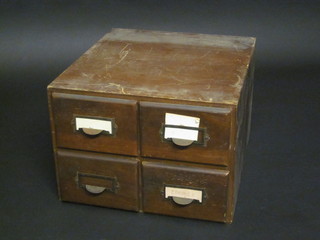 A 4 draw table top filing chest containing a collection of various stamps