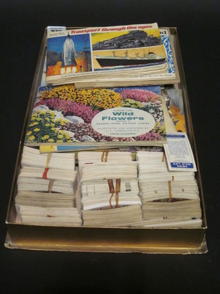 A collection of various tea cards and tea card albums