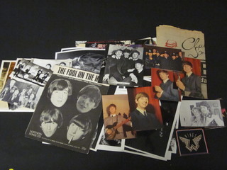 A shallow blue plastic crate containing a collection of Beatles memorabilia including magazines, postcards etc