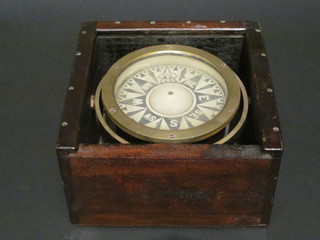A Marine compass with gimbal, contained in a brass and  wooden carrying case