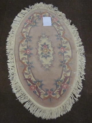 an oval peach ground Chinese rug 54" x 28"