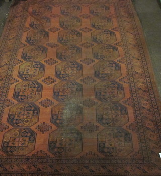 A red ground Afghan rug with 24 octagons to the centre, some  wear and light holes to edge 134" x 92"