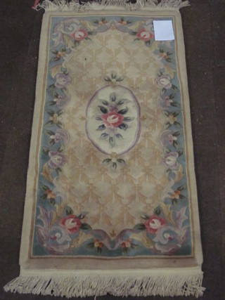 A yellow ground and floral patterned Chinese rug 60" x 30"