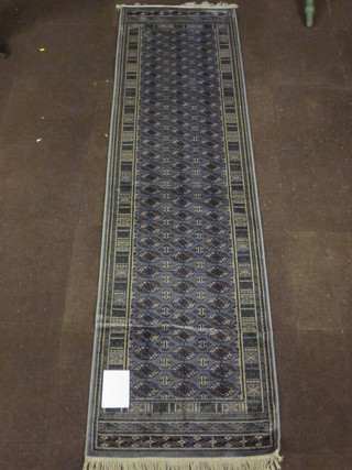 A grey ground Bokhara style runner with numerous octagons to the centre 111" x 30"