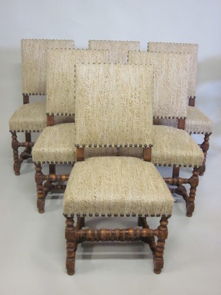A set of 6 walnut high backed dining chairs, raised on turned and block supports with H framed stretcher