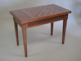 A mahogany and parquetry rectangular chess table, fitted a  drawer, the top inlaid a chess board and raised on square tapering  supports 32"