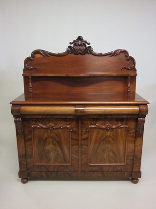A Victorian mahogany chiffonier with raised back, the base fitted  2 long drawers above 2 cupboards enclosed by arched panelled  doors, raised on bun feet 49"  ILLUSTRATED