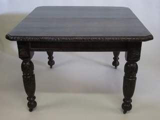 A Victorian carved oak extending dining table with 1 extra leaf, raised on turned supports 41"
