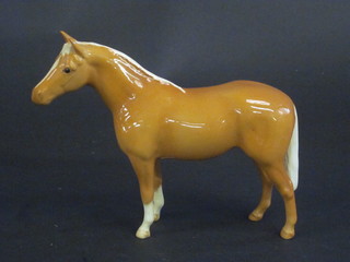 A Beswick figure of a standing Palomino horse 6"   ILLUSTRATED