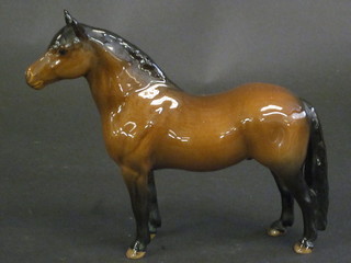 A Beswick figure of a standing bay stallion, 7"   ILLUSTRATED