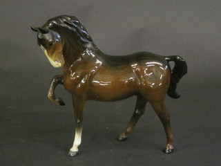 A Beswick figure of a standing bay stallion with front right hoof crooked, 8"