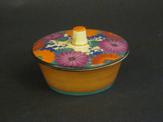 A circular Clarice Cliff Gay Day pattern jar and cover 3", slight  chip? to finial