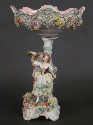 A "Meissen" porcelain table centre piece in the form of a ribbonware bowl supported by 2 figures in the form of a lady and  gentleman 16, stand f, some chips,  ILLUSTRATED