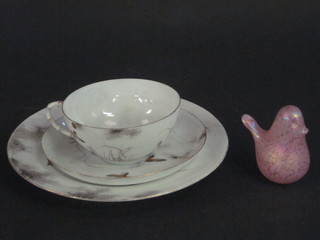A glass paperweight in the form of a seated bird 3 1/2" together with an egg shell porcelain cup saucer and plated decorated birds