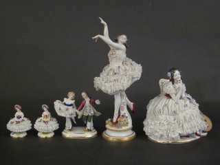 A Continental porcelain figure of a seated Crinoline lady with mandolin 8", 1 other - Ballerina 14", a pair - Ladies 4" and 1  other - dancing couple 5"