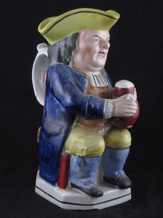A 19th Century Staffordshire Toby jug in the form of a seated gentleman with pipe and pint of beer 9", base chipped