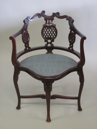 An Edwardian mahogany corner chair with pierced slat back