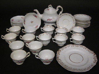 A Victorian 17 piece white glazed tea set with floral decoration comprising teapot - cracked, 8 cups and 8 saucers - cracked,  together with a 17 piece Victorian Copeland and Garrett gilt  banded tea service comprising 2 9" dinner plates - 1 cracked, 6  tea cups - 3 cracked