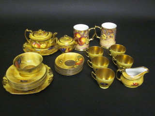 A Worcester style 4 piece tea service comprising teapot, lidded  sucrier, cream jug and twin handled plate marked A Roott,  together with 6 similar circular plates decorated fruit 6 1/2", a  twin handled bread plate 9", f, circular sugar bowl 5", 5 cups, 6  saucers, all marked Christie and 2 tankards painted by Delaney