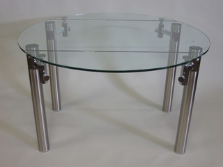 A circular plate glass topped Designer breakfast table, raised on  chromium plated supports