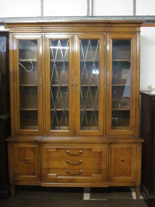 A Thomasville American cherry wood break front display cabinet  with moulded cornice, fitted adjustable shelves enclosed by  glazed panelled doors, the base fitted 3 long drawers flanked by a  pair of cupboards 60"