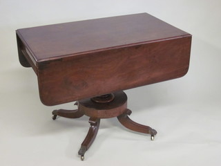 A 19th Century mahogany pedestal Pembroke table fitted a  drawer and raised on a turned column with splayed feet 38"