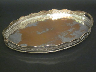An oval silver plated twin handled and galleried tea tray 24"
