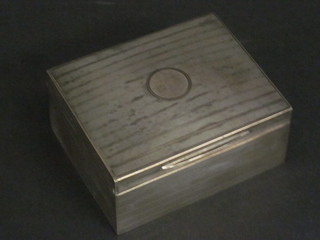 A silver cigarette box with engine turned decoration and hinged lid, Birmingham 1945 4 1/2"