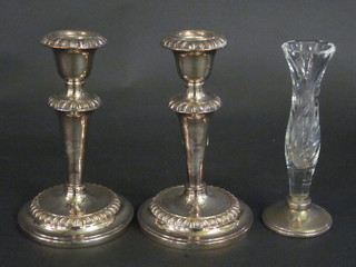 A pair of silver candlesticks with gadrooned decoration 7" and a  cut glass vase raised on a silver foot 6 1/2"
