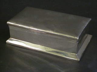 A rectangular silver cigarette box with hinged lid, London 1928 7",