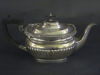 An oval silver plated teapot with demi-reeded decoration