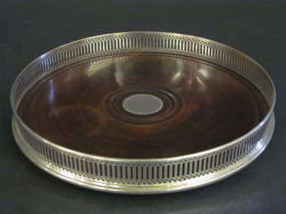 A modern circular pierced silver galleried tray with mahogany  base 10"