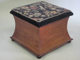 A Victorian square waisted mahogany footstool with Berlin woolwork seat, raised on turned supports 22"