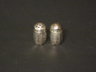 A pair of American planished Sterling silver miniature pepperettes