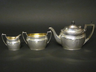 A Georgian style oval engraved silver 3 piece tea service  comprising teapot, twin handled sugar bowl and cream jug,  Sheffield 1907, 25 ozs  ILLUSTRATED