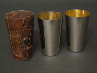 2 silver plated beakers contained in a leather carrying case