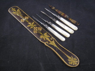 4 nut picks with mother of pearl handles, a manicure implement  and a wooden paper knife