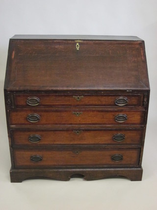 A Georgian oak bureau, the fall front revealing a well fitted  interior above 4 long drawers, raised on bracket feet 40"