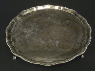 A silver salver with bracketed border, raised on 4 ball and claw feet, Birmingham 1919, 51 ozs