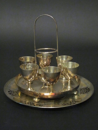 A silver plated 6 piece egg cruet together with a circular pierced silver plated dish