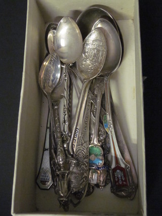 A collection of various Sterling and enamel souvenir spoons